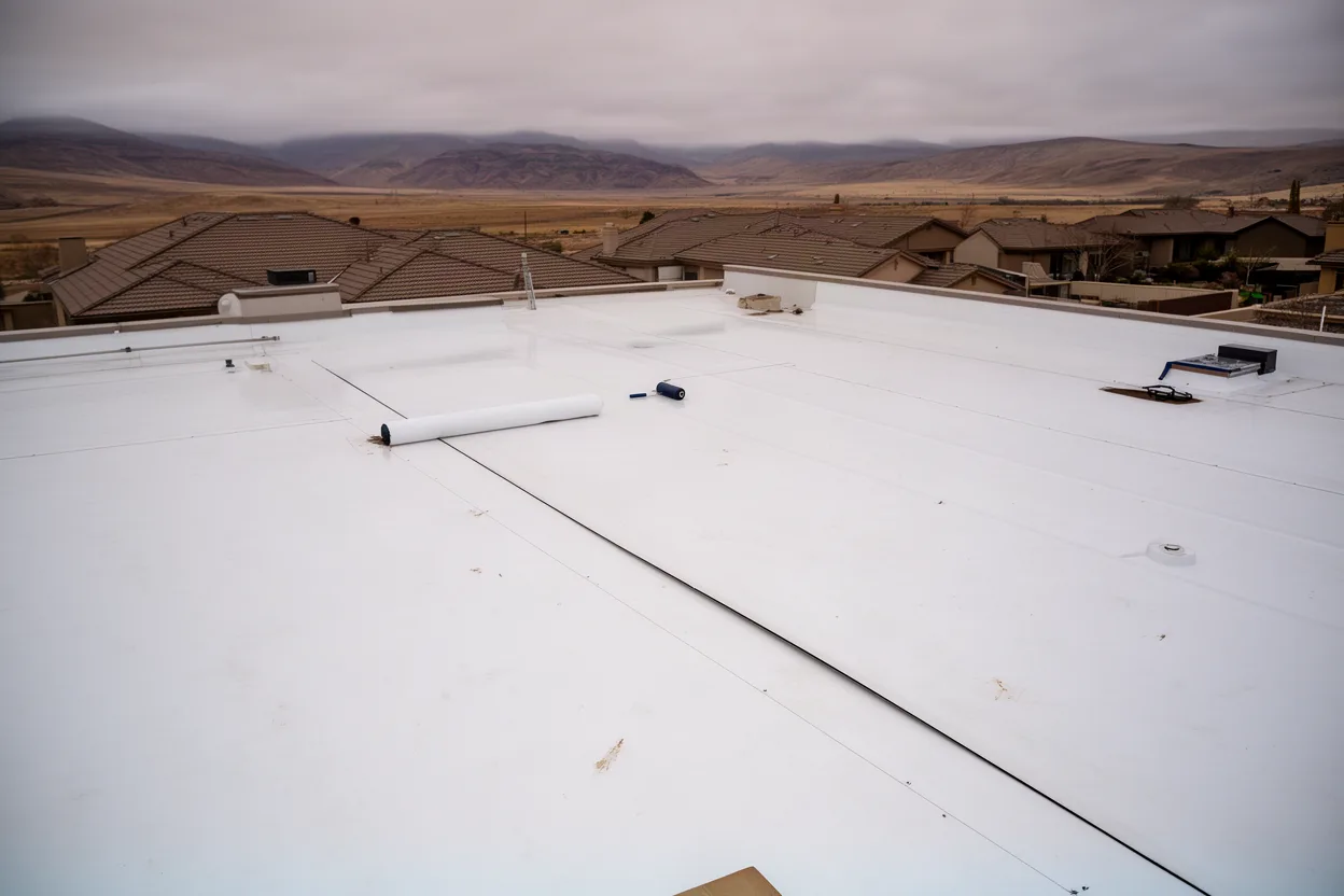 A flat membrane roof seam being rolled
